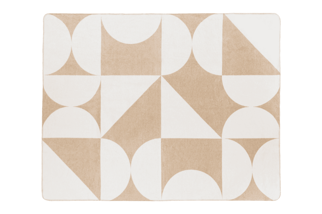 Packshot of a beige and white geometric patterned throw blanket.